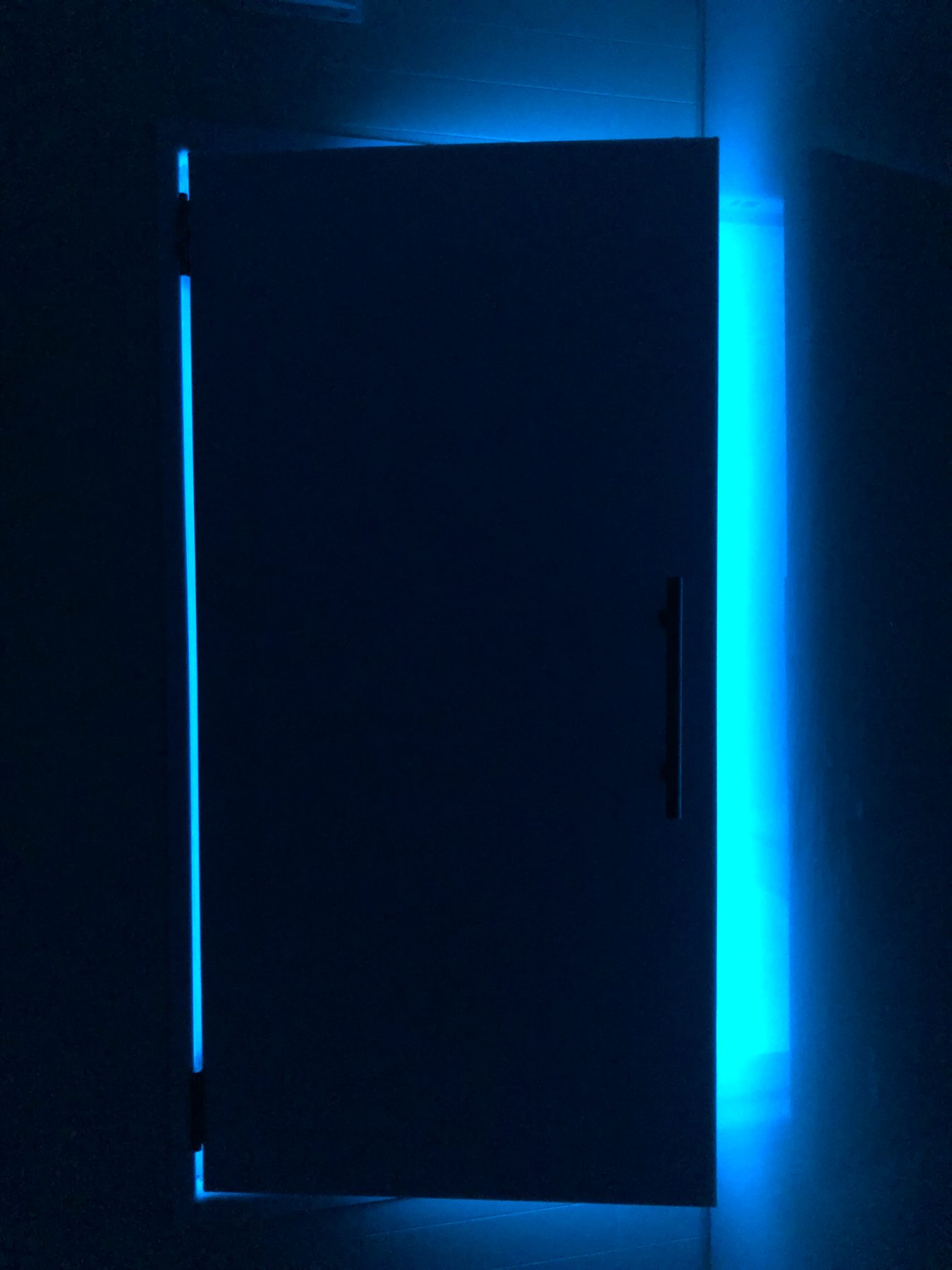The float room glowing blue through a softly lit doorway